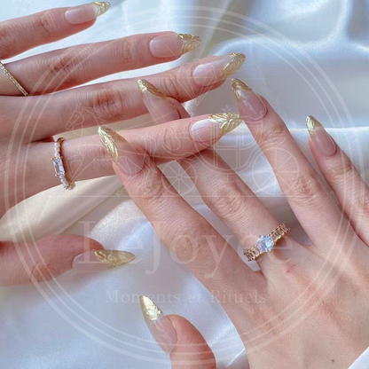Close-up macro shot of the nail tip showing the raised, crumpled gold foil texture that mimics molten metal against the glossy nude background.