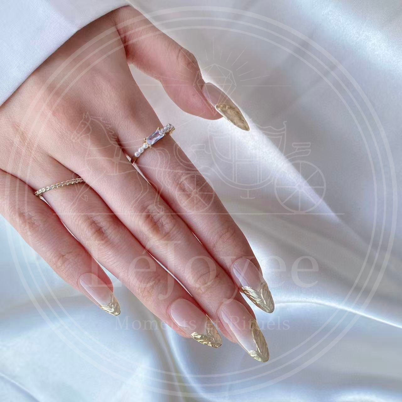 Angled view of the hand wearing Gilded Flow nails, capturing the high-shine reflection of the metallic gold tips under natural light.