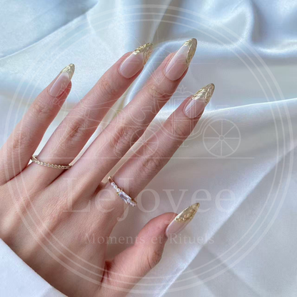 Luxury handmade press-on nails "Gilded Flow" featuring a sheer nude base with textured, molten gold chrome french tips on long almond nails.
