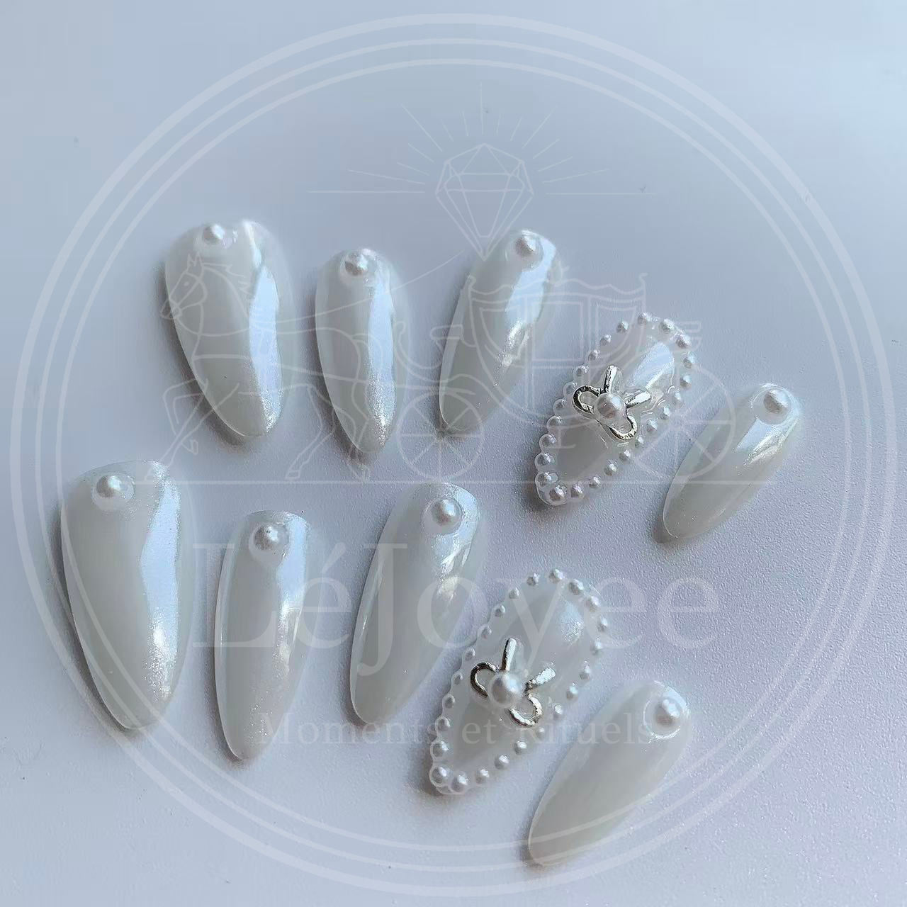 Luxury handmade press-on nails "Moonlit Ballet" featuring a lustrous white pearl chrome finish, accented with a silver metallic bow and a delicate micro-pearl frame.