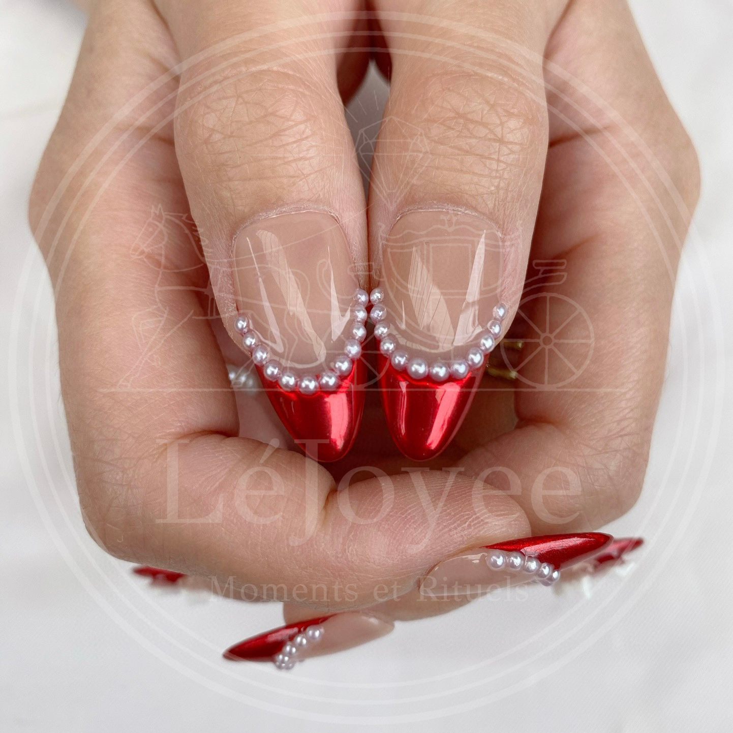 Macro shot showing the smile line of the french tip lined with tiny, lustrous micro-pearls, adding a vintage elegant touch to the design.