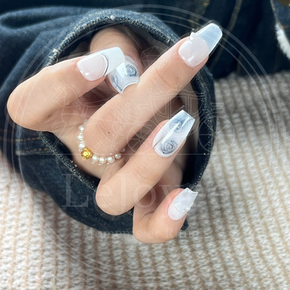 Artistic display of the "Azure Sketch" nail set, highlighting the clean, elegant contrast between the dark blue ink and the pristine white background.