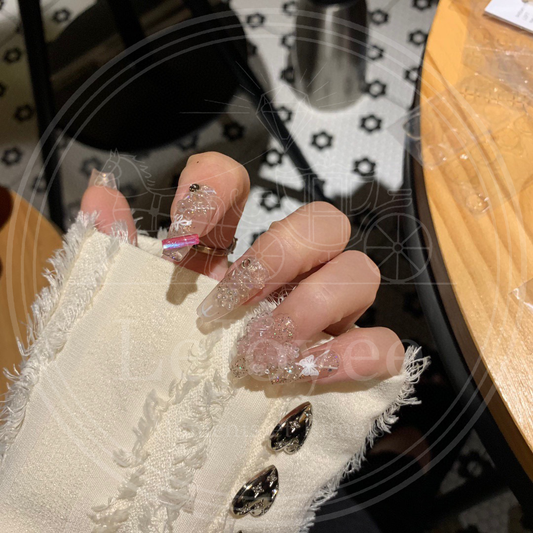 Clear glitter nails accented with edgy small black rhinestones and vibrant hot pink rectangular studs for a Y2K aesthetic.