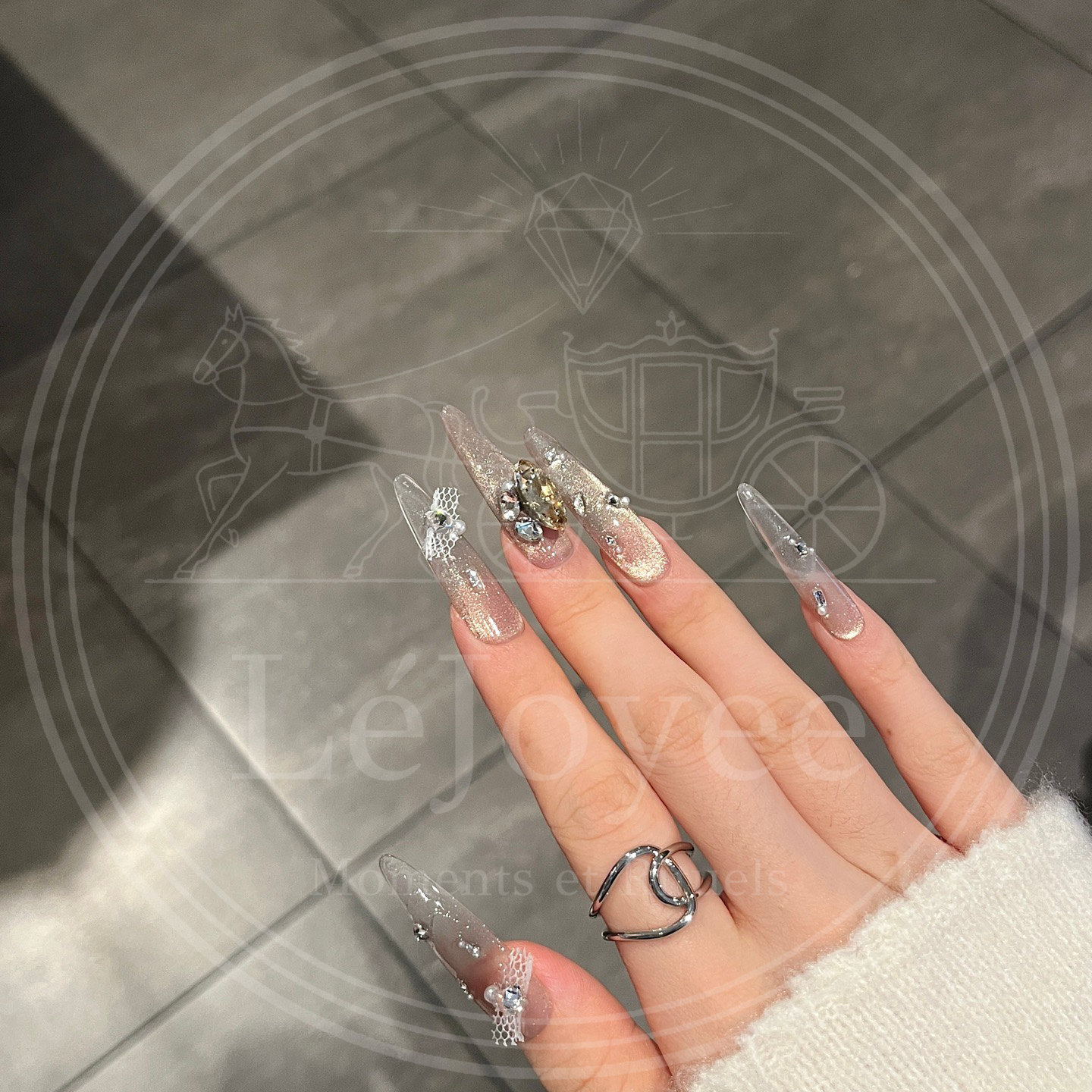 Elegant nude handmade press-on nails designed with multicolour rhinestones, ribbons, and luminous gradient base.