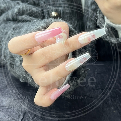 Close-up of the thumb and middle finger showing intricate oil-painting style rose blooms with subtle green leaves on a creamy nail base.