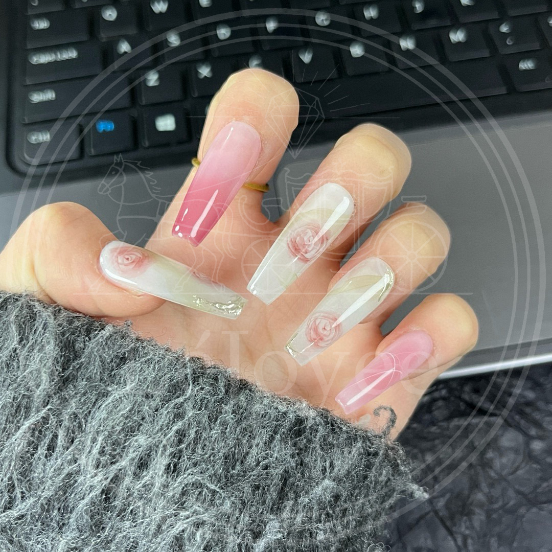 Artistic flatlay of the Roseate Sonnet nail set, highlighting the soft, romantic color palette of dusty rose, cream, and faint sage green.