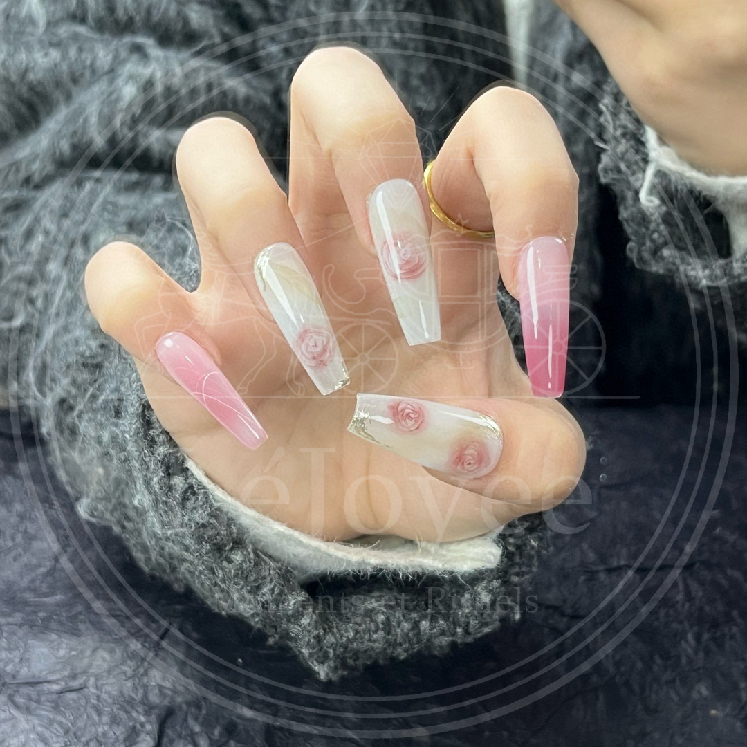 Detail shot of the index and pinky fingers featuring a seamless "blush" pink ombre effect that mimics a natural flush or rose petal texture.