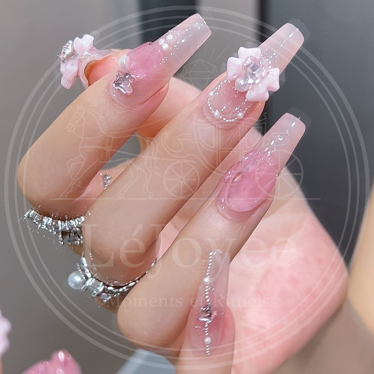 Soft pink handmade press-on false nails designed with pastel bows and rhinestones, capturing an elegant, dreamy aesthetic.