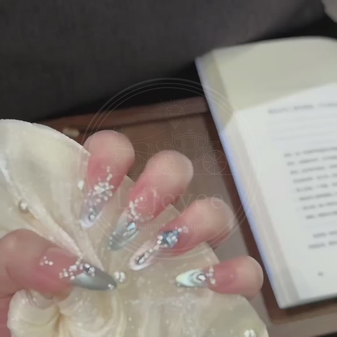 Video demonstrating the dazzling light reflection of the aquamarine rhinestones and the shifting icy blue magnetic effect on the Crystalline Azure nail set.