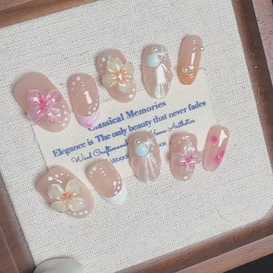 Video demonstrating the glossy finish and the raised, dimensional texture of the jelly sakura flowers and shimmering seashells on the Sakura Shores nails.