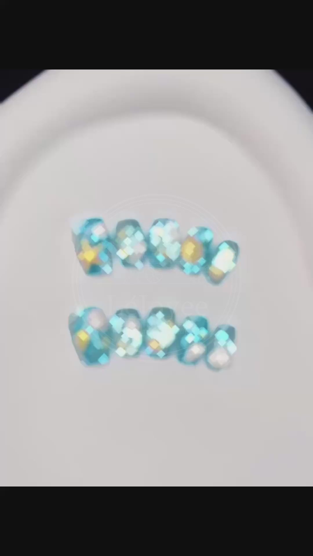 Video capturing the glossy, water-like finish and the dimensional details of the seashell art on the Seafoam Daydream press-on nails.
