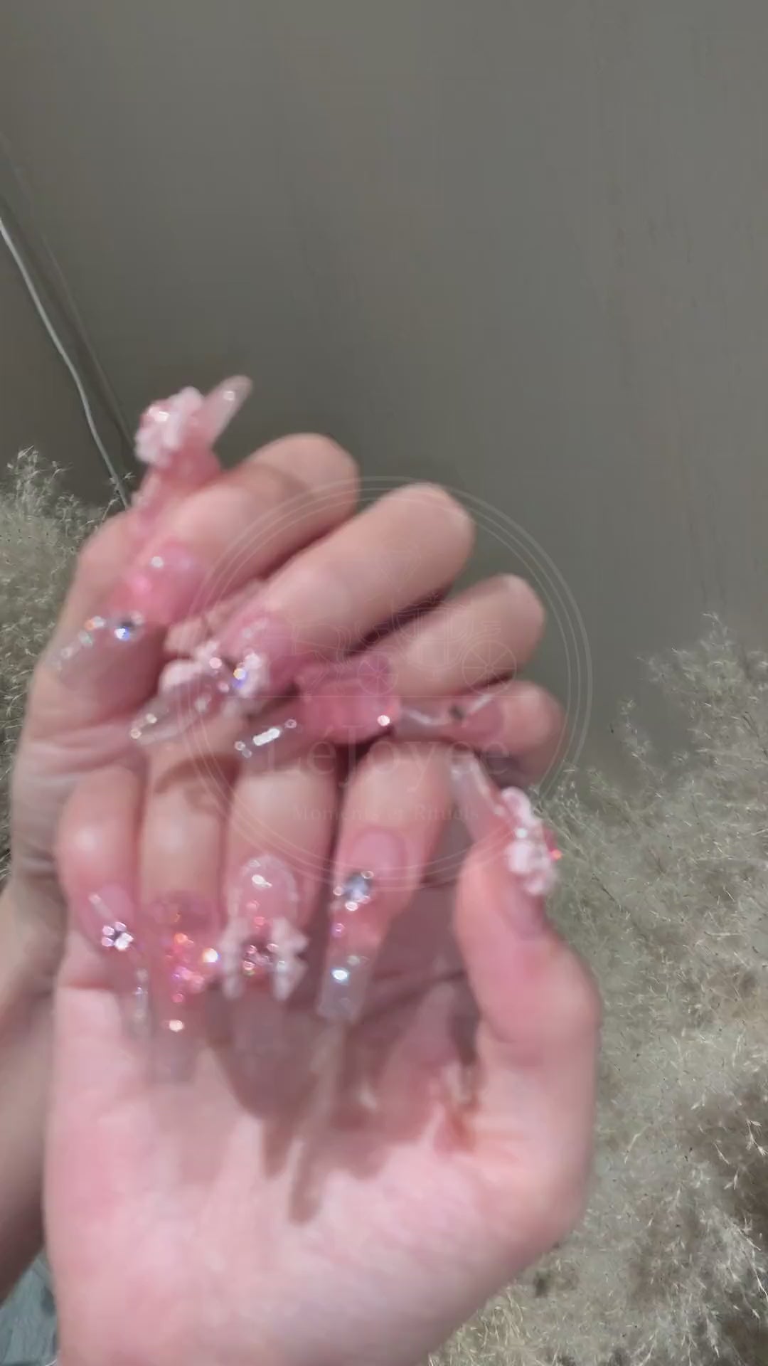 A luxurious pink floral handmade press-on nail set with sparkling rhinestones and accents, reflecting feminine elegance and soft beauty.