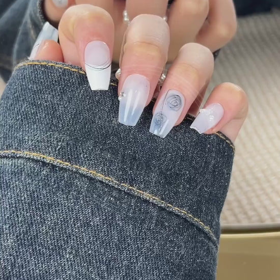 Video showcasing the smooth, porcelain-like finish of the white base and the delicate details of the hand-drawn blue roses on the Azure Sketch nails.